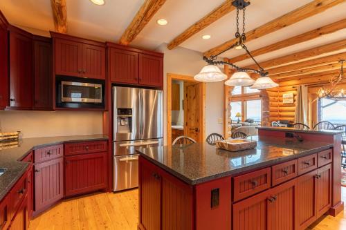a kitchen with red cabinets and a large island at Good Day Sunshine in Lenoir