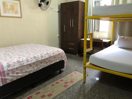 a bedroom with two bunk beds and a window at Zen Garden Hostel Mirandópolis in Sao Paulo