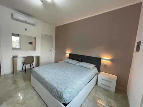 a bedroom with a bed and a desk in it at Appartamento confortevole M.I. Casa in Cusano Milanino