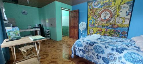 a bedroom with a bed and a painting on the wall at Alojamientos N&S in Fortuna