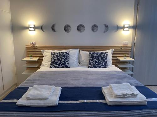 a bedroom with a large bed with two towels on it at Residenza Borgo Trento SUNDAY in Verona