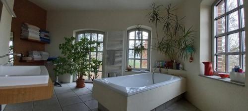 a large bathroom with a large tub and two windows at Einfachlosmachen Turmzimmer 