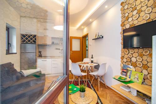 a living room with a kitchen and a dining room at Apartment Sunčana dolina in Zlatibor
