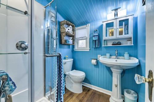a blue bathroom with a toilet and a sink at Lakefront Home, Close to Mt Southington! in Wolcott