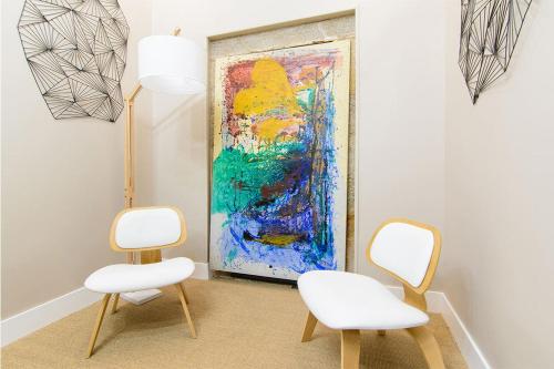a room with two chairs and a painting on the wall at Pazo de Mendoza in Baiona