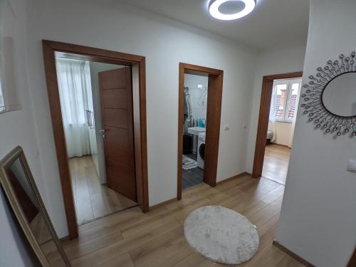 a hallway with two doors and a mirror at Ika LuX apartmani 4* in Sjenica