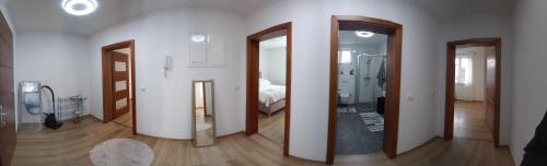 uma sala com quatro espelhos numa parede com um quarto em Ika LuX apartmani 4* em Sjenica