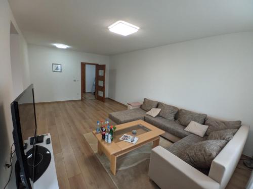 a living room with a couch and a coffee table at Ika LuX apartmani 4* in Sjenica