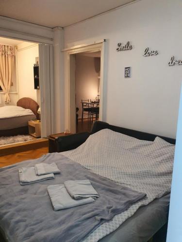 a bedroom with a bed with two towels on it at Sunflower apartment in Žarkovo