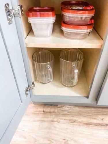 a cupboard with bowls and other dishes in it at Renovated Bungalow Getaway in Philomath