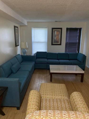 a living room with a blue couch and a table at Island Avenue in Philadelphia