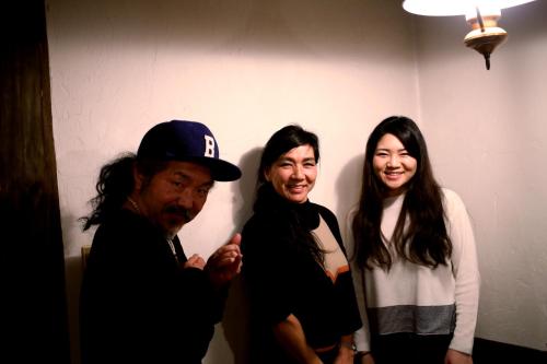 a group of three people standing in a room at Pension Belnina in Hakuba