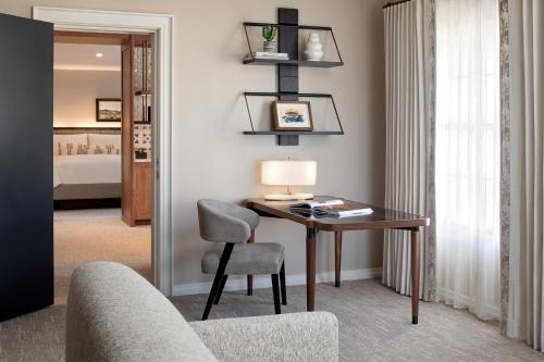 a living room with a desk and a chair at Fairmont Scottsdale Princess in Scottsdale