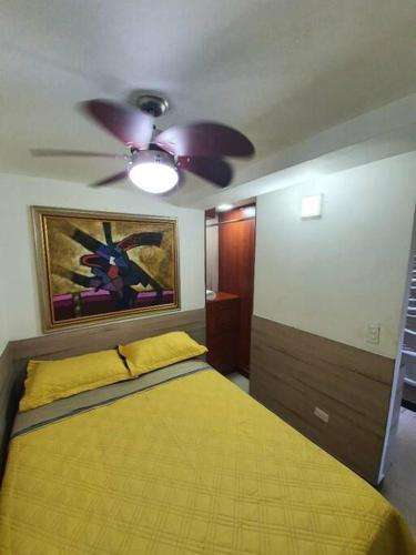a bedroom with a bed and a ceiling fan at R.1111 Estudio ejecutivo, práctico, en el centro. in Panama City