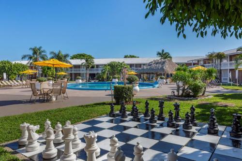 a chessboard in front of a resort with a pool at Best Western Palm Beach Lakes in West Palm Beach