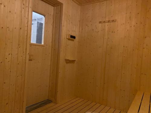 a sauna with wooden walls and a window at Sunway City Onsen COSY HOME Tambun Ipoh in Ipoh