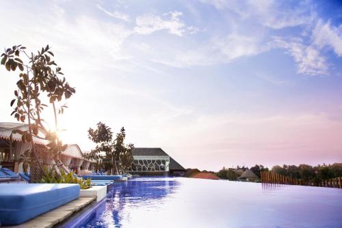 an image of a swimming pool at a resort at TS SUITES Seminyak Bali in Legian