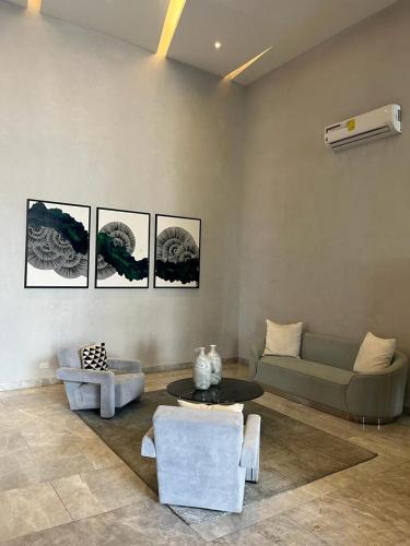 a living room with a couch and a table at Signature Point Bella Vista, Sea View 2 BR in Panama City