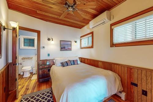 a bedroom with a bed and a wooden ceiling at Commercial Street Retreat in Provincetown