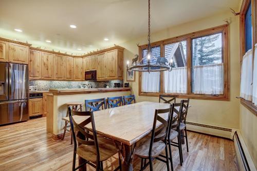 a kitchen with a wooden table and chairs at The Perfect Large Family Retreat condo in Beaver Creek