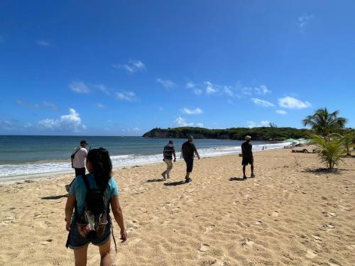 a group of people walking on the beach at Hostal Johnnier Macao Punta Cana in Punta Cana