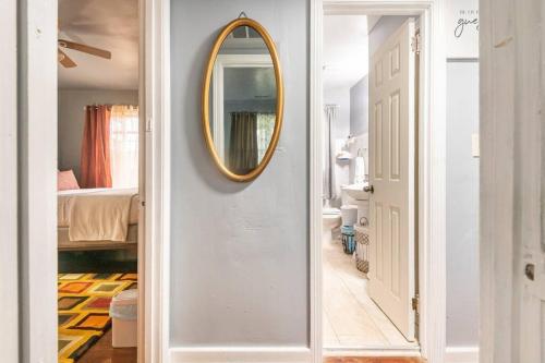 a hallway with a mirror and a bathroom with a bed at Mystic Island #1 in Birmingham
