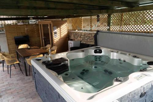 a bath tub sitting on top of a patio at Holiday home in Nagyvazsony - Balaton 43410 in Nagyvázsony