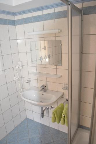 a bathroom with a sink and a mirror at Hotel Garni Bergwelt in See