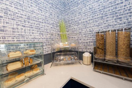 a bakery with a bunch of pastries and other foods at AmericInn by Wyndham Duluth in Duluth