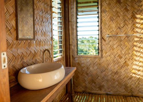 a bathroom with a large bowl sink on a counter at Ocean Green Eco Lodge in Puerto Princesa City