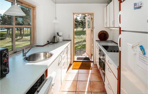 a kitchen with a sink and a refrigerator at Amazing Home In Samsø With Kitchen in Onsbjerg