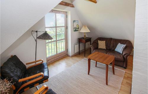 a living room with a couch and a table at Amazing Home In Samsø With Kitchen in Onsbjerg
