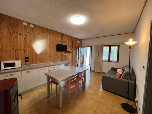 a kitchen and living room with a table and a couch at Apartment in Ledro - Ledrosee 43436 in Ledro