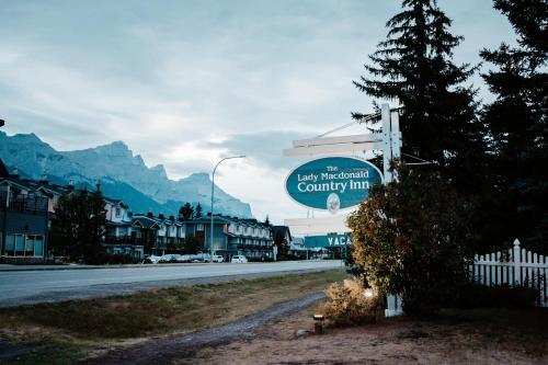 a sign for a country inn on the side of a road at Lady MacDonald Country Inn in Canmore