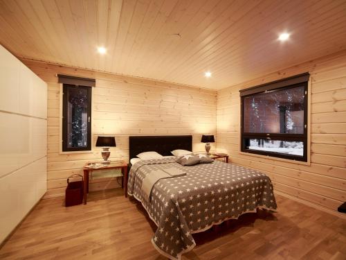 1 dormitorio con 1 cama, 2 mesas y una ventana en Villa Borealis, en Sappee