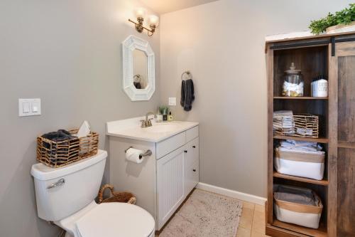 a bathroom with a toilet and a sink at Vineyard Setting With 180 Panoramic Lake Views in Lower Lake