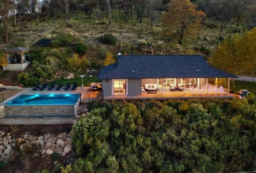an aerial view of a house with a swimming pool at Vineyard Setting With 180 Panoramic Lake Views in Lower Lake