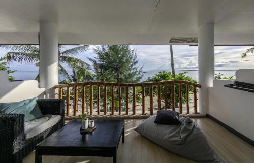 a living room with a couch and a table at Ocean Vida Beach and Dive Resort in Daanbantayan