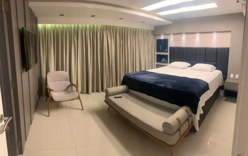 En eller flere senge i et værelse på Mansão Fragata