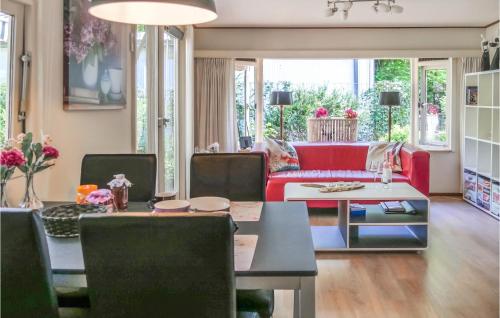a living room with a red couch and a table at T Vosje in Emst