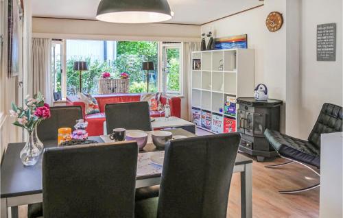 a living room with a dining room table and chairs at T Vosje in Emst