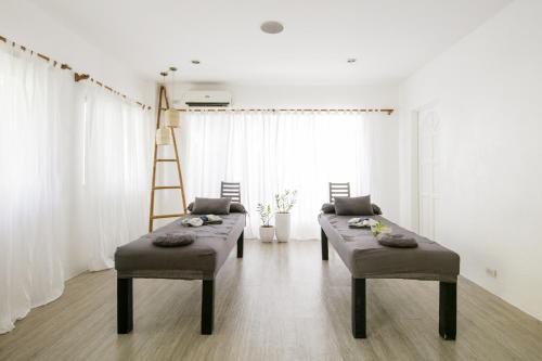 a living room with two stools and a ladder at Ocean Vida Beach and Dive Resort in Daanbantayan