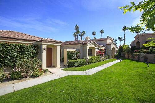 a house with a green lawn in a yard at Upscale Palm Valley Condo-Acrisure Arena 4mi-El Paseo 6mi-Club Privileges Golf, Tennis, Pickleball in Palm Desert