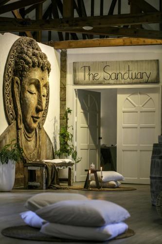 a room with a statue of a buddha at Ocean Vida Beach and Dive Resort in Daanbantayan