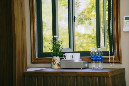 a counter with two bottles of water and a window at Ninh Binh The View Point Home & Spa in Ninh Binh