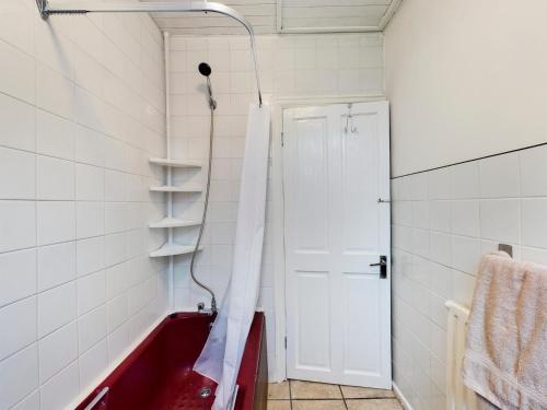 a shower with a red tub in a bathroom at 2BD City Centre Flat nr Anfield Stadium Liverpool in Liverpool