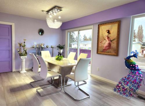 a dining room with a table and a parrot on the wall at private single room in a house in Richmond