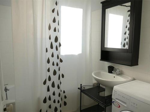 a bathroom with a sink and a shower curtain at Appartement Trégastel, 3 pièces, 4 personnes - FR-1-368-45 in Trégastel