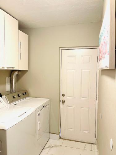 a kitchen with a white door and a white stove at 3 miles to Siesta Key #1 Beach in America in Sarasota