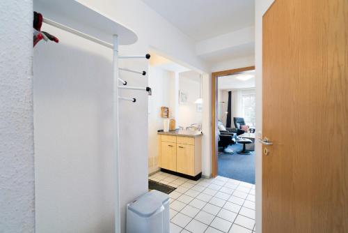 a bathroom with a toilet and a desk in a room at Gorch-Fock-Park App 3 in Timmendorfer Strand